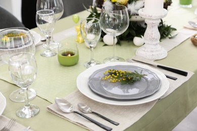 Beautiful Easter table setting with floral decor indoors