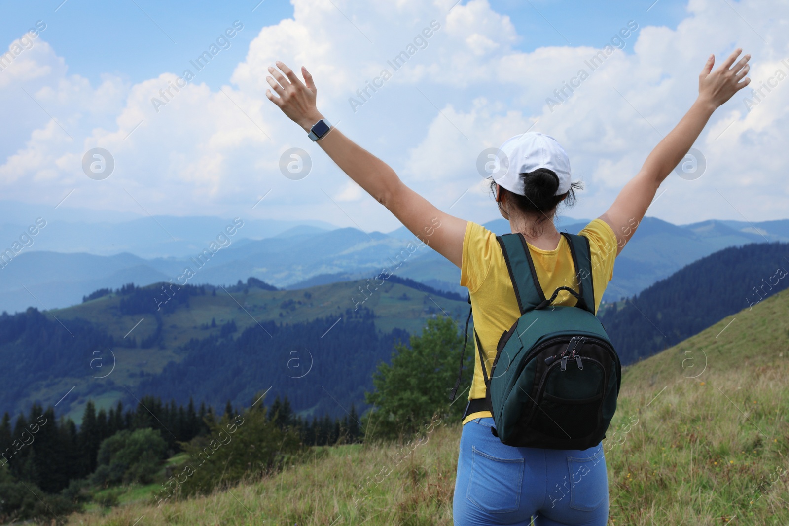 Photo of Woman with backpack in wilderness. Mountain landscape