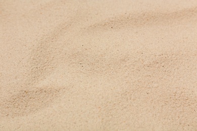 Photo of Dry sand on beach as background, closeup