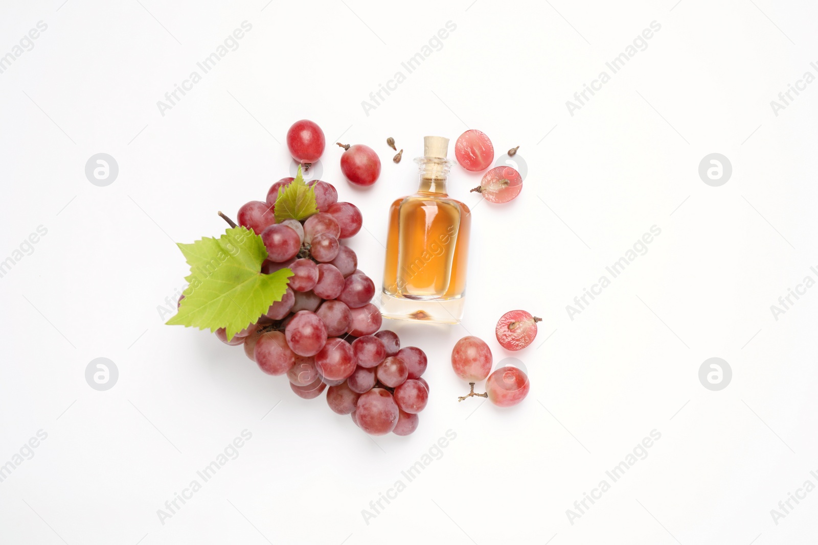 Photo of Composition with bottle of natural grape seed oil on white background, top view. Organic cosmetic