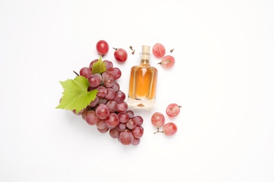 Composition with bottle of natural grape seed oil on white background, top view. Organic cosmetic