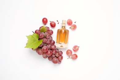 Photo of Composition with bottle of natural grape seed oil on white background, top view. Organic cosmetic