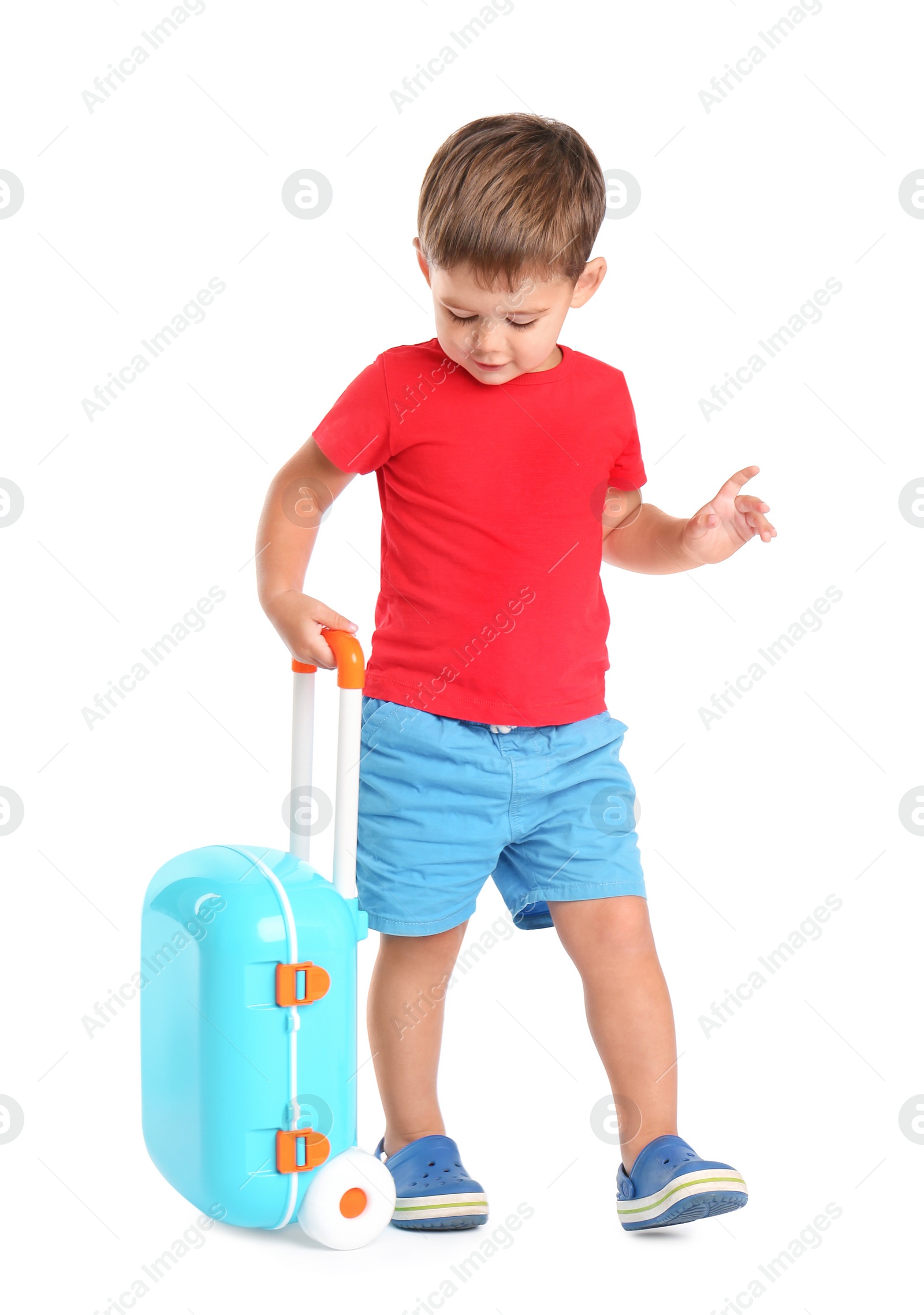 Photo of Cute little boy with blue suitcase on white background