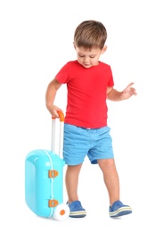 Cute little boy with blue suitcase on white background