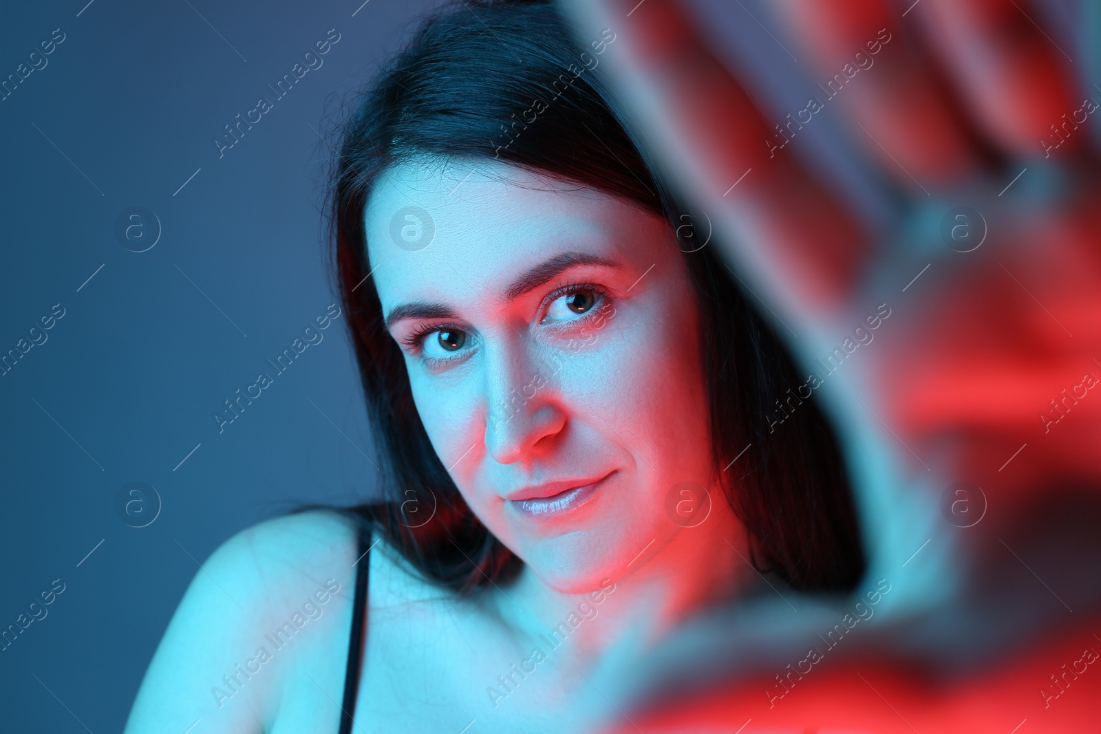 Photo of Beautiful young woman on color background, closeup