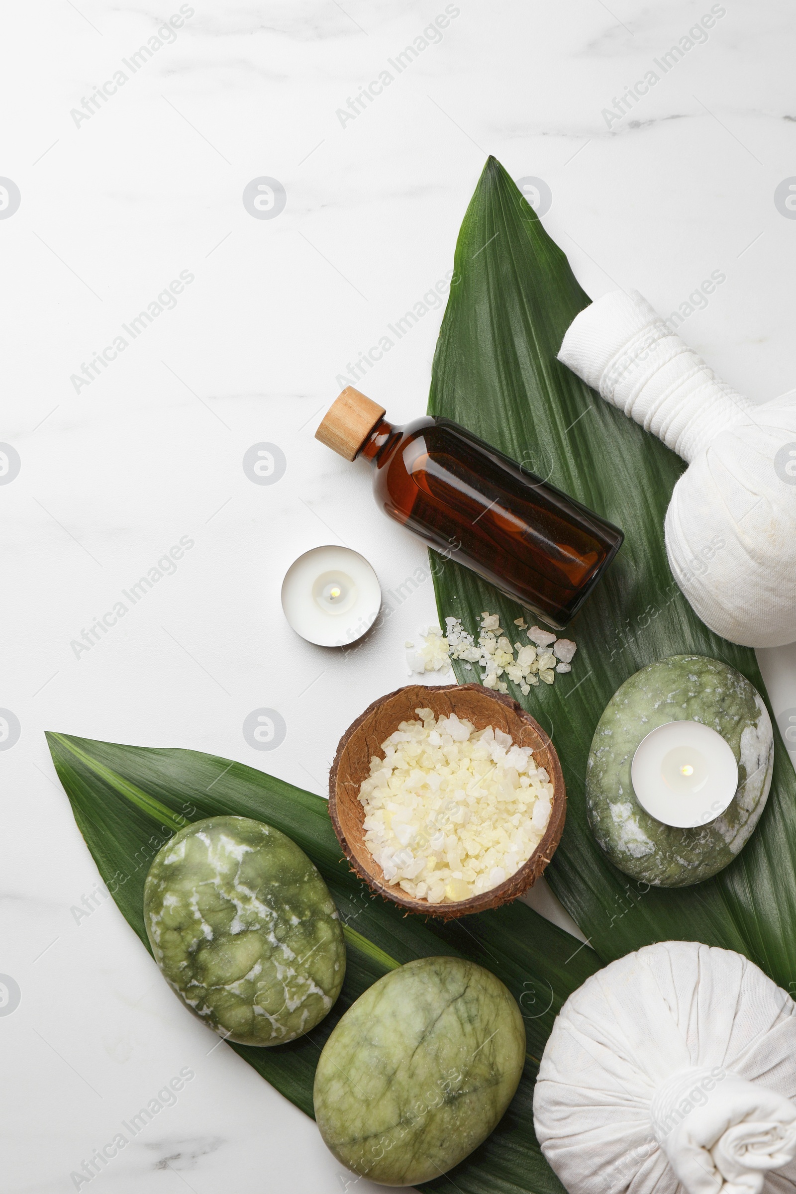 Photo of Flat lay composition with spa products .and candles on white marble table. Space for text