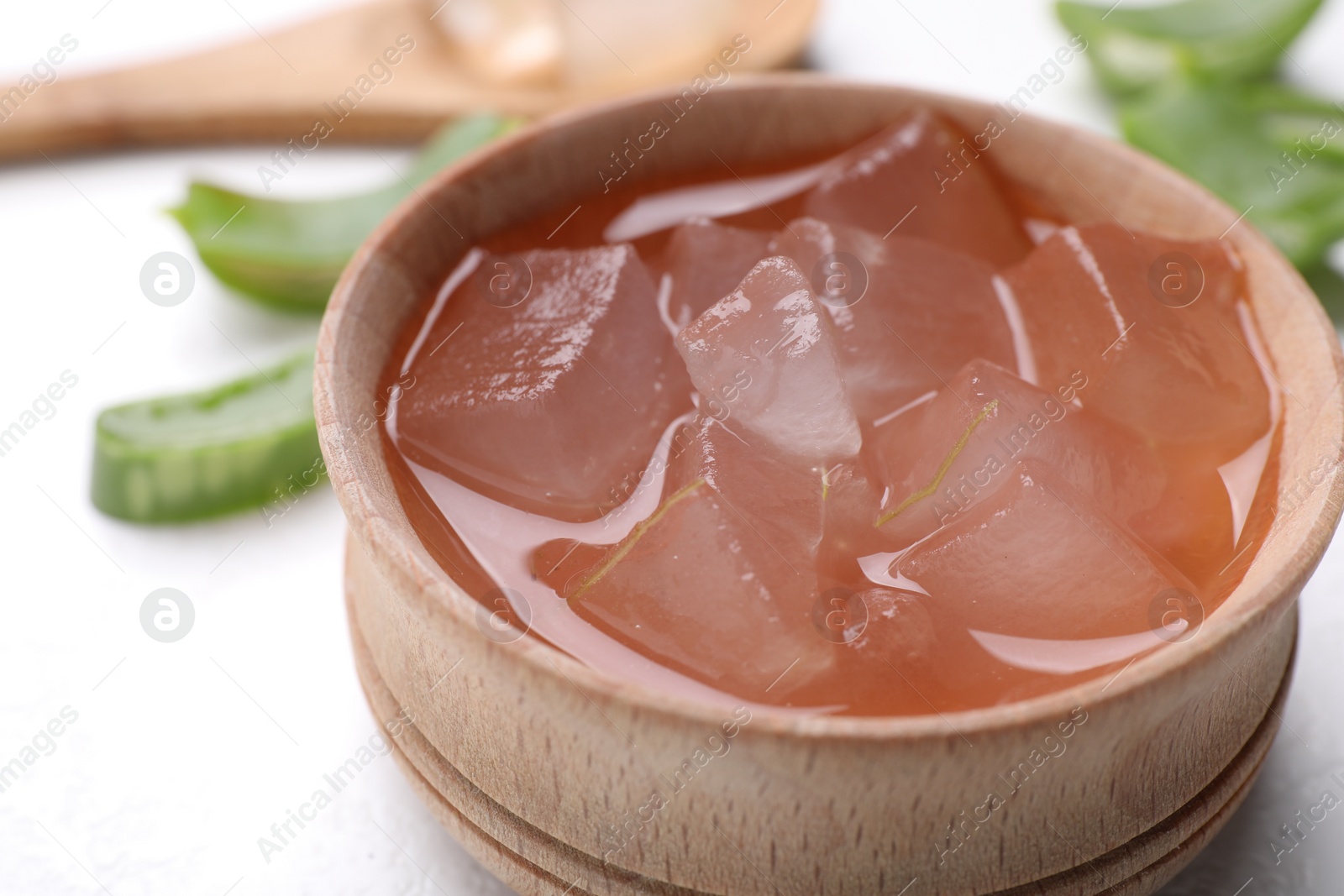 Photo of Aloe vera gel in bowl on white background, closeup