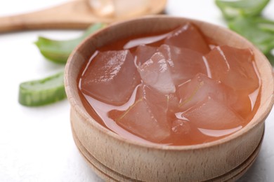 Aloe vera gel in bowl on white background, closeup