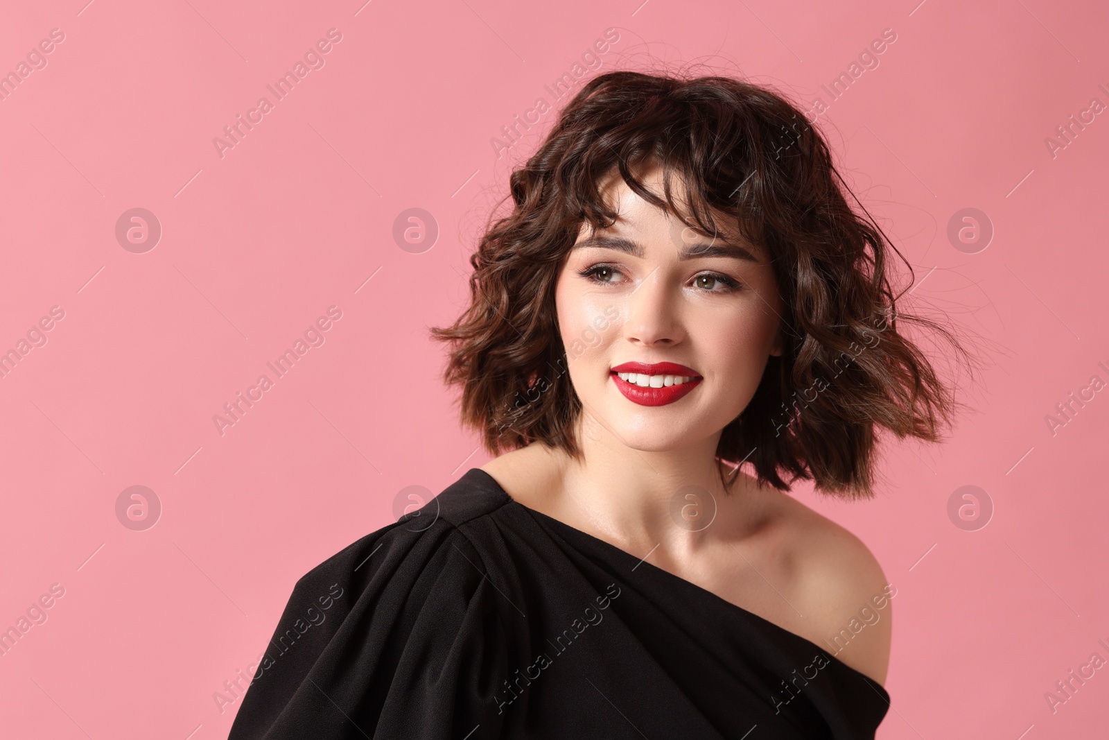 Photo of Portrait of beautiful young woman with wavy hairstyle on pink background. Space for text