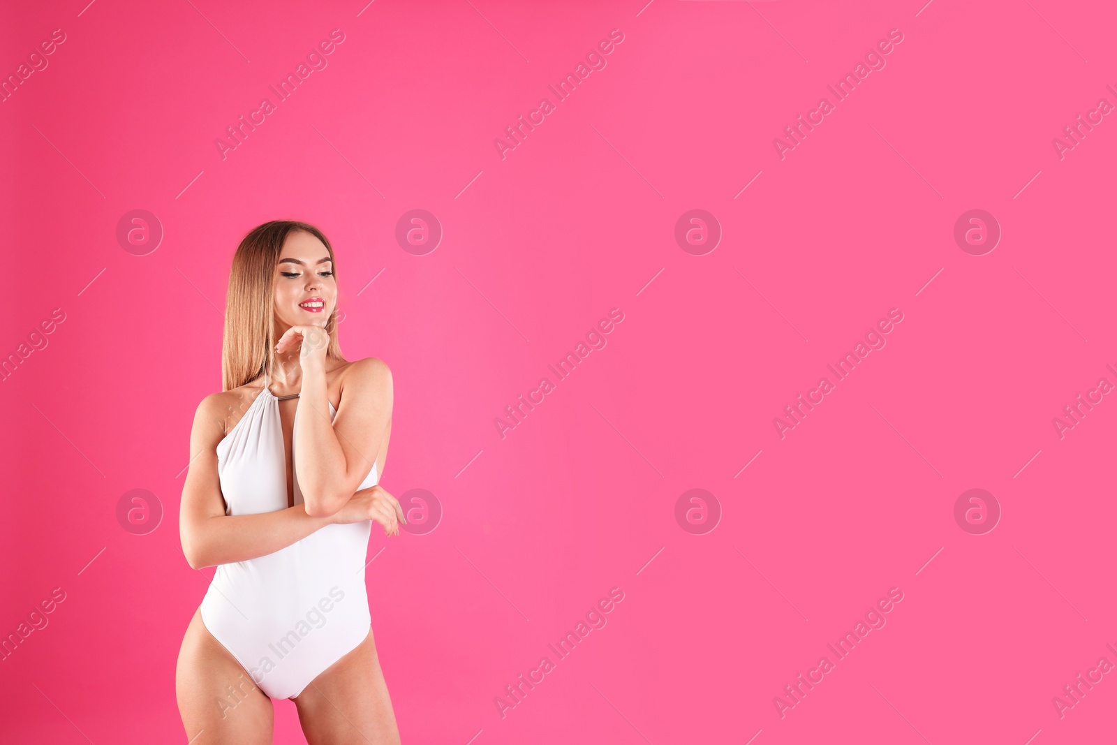 Photo of Pretty sexy woman with slim body in stylish bikini on color background, space for text