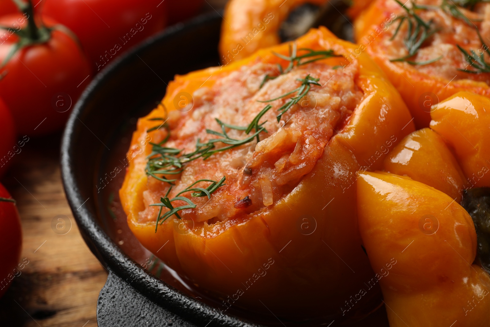 Photo of Tasty stuffed peppers in pan on table, closeup