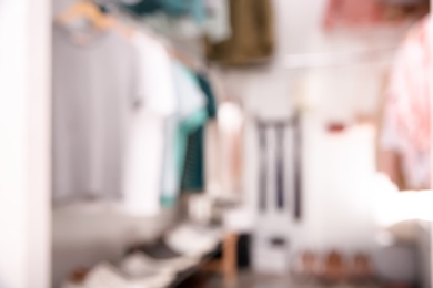 Photo of Blurred view of modern dressing room with stylish clothes