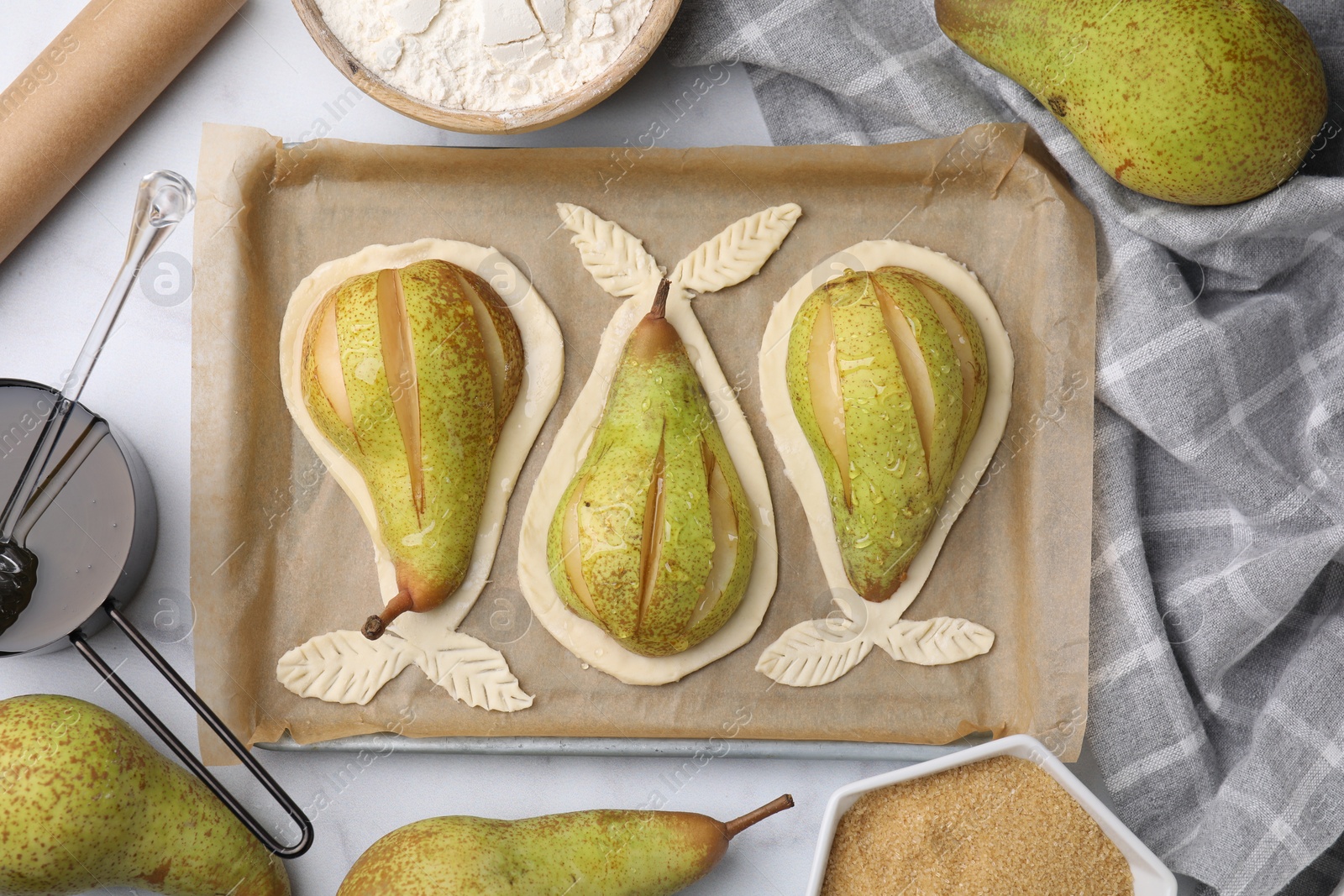 Photo of Tray with raw dough and fresh pears on white marble table, flat lay