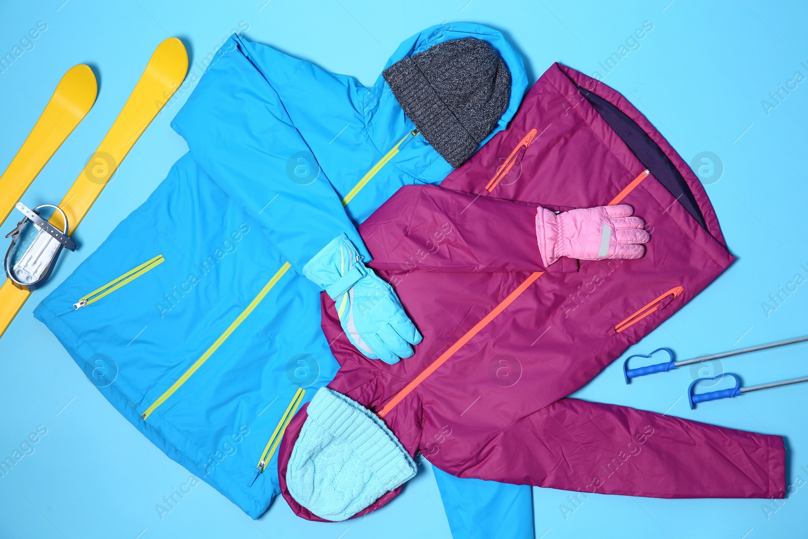 Photo of Set of warm sports clothes on color background, flat lay. Winter vacation