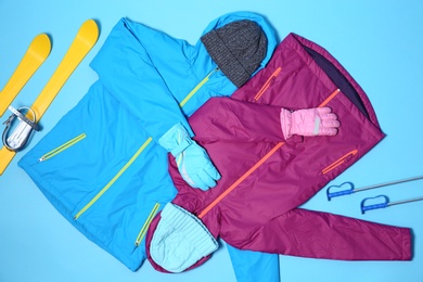 Photo of Set of warm sports clothes on color background, flat lay. Winter vacation