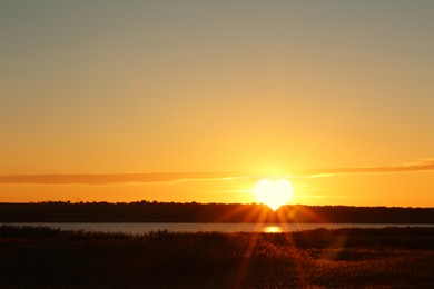 Image of Picturesque view of beautiful sunset on riverside