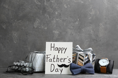 Photo of Composition with greeting card on light grey stone background. Happy Father's Day