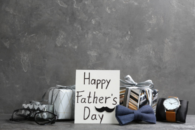 Composition with greeting card on light grey stone background. Happy Father's Day