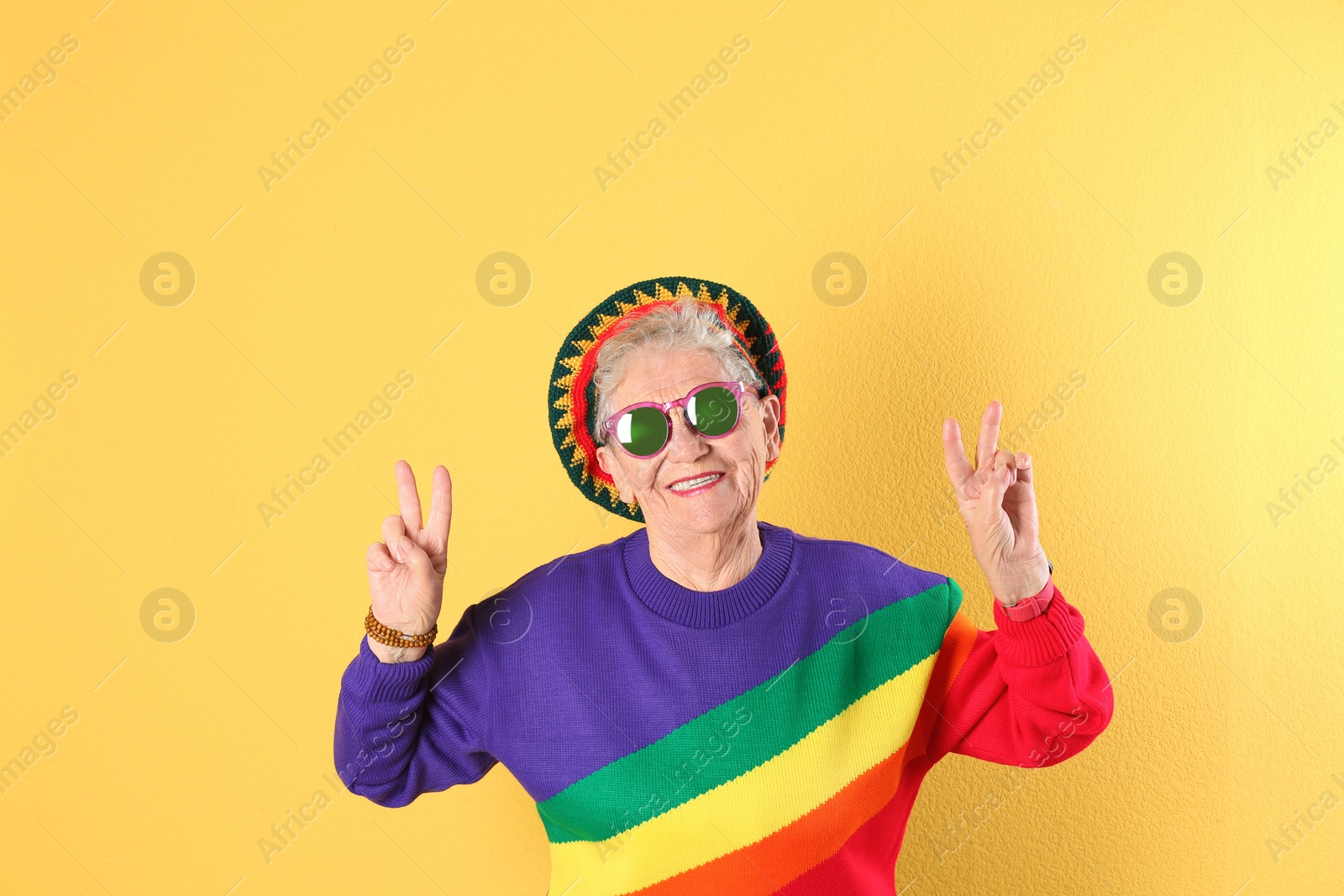 Photo of Portrait of cool grandmother on color background