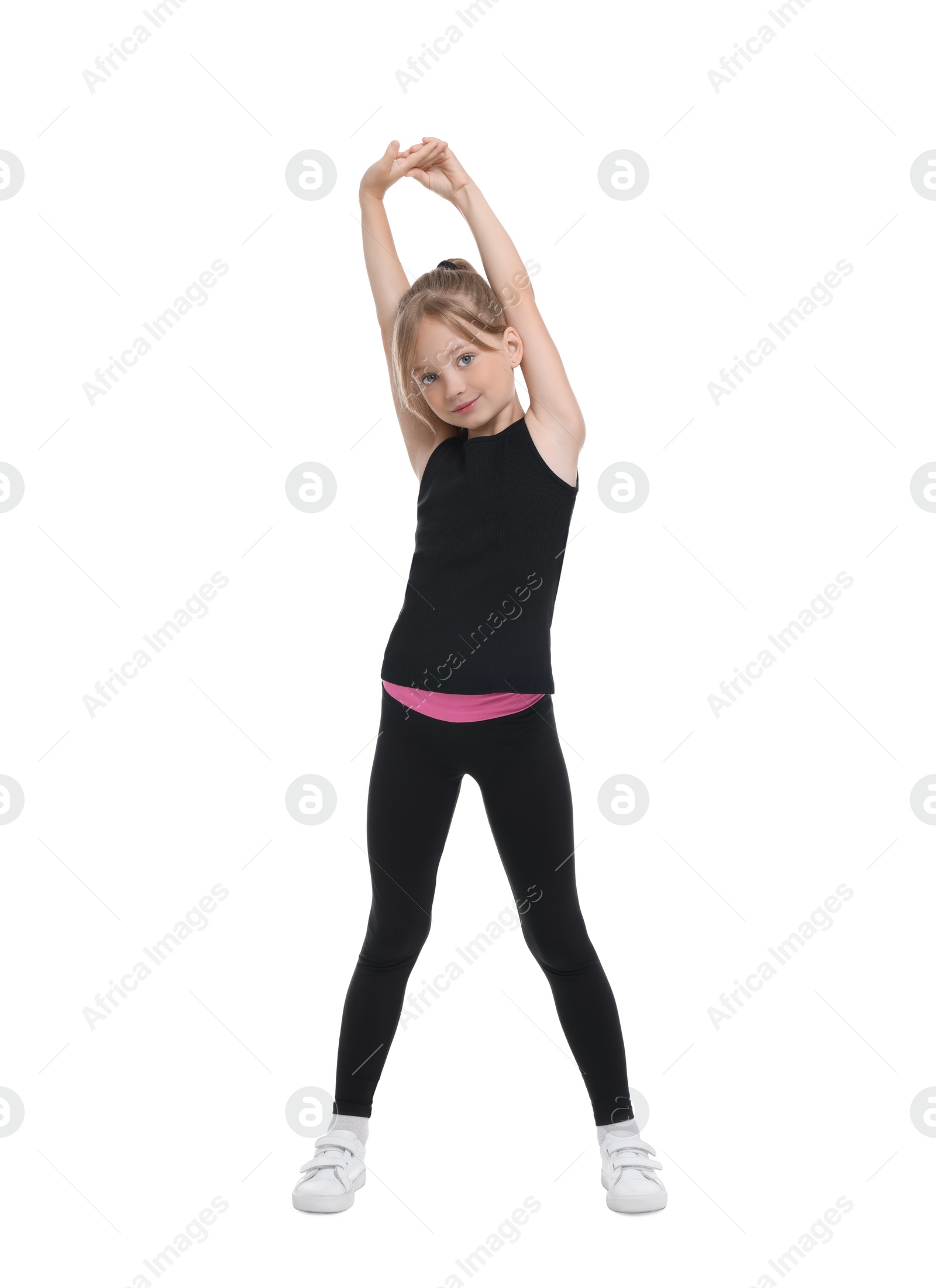 Photo of Little girl doing morning exercise on white background