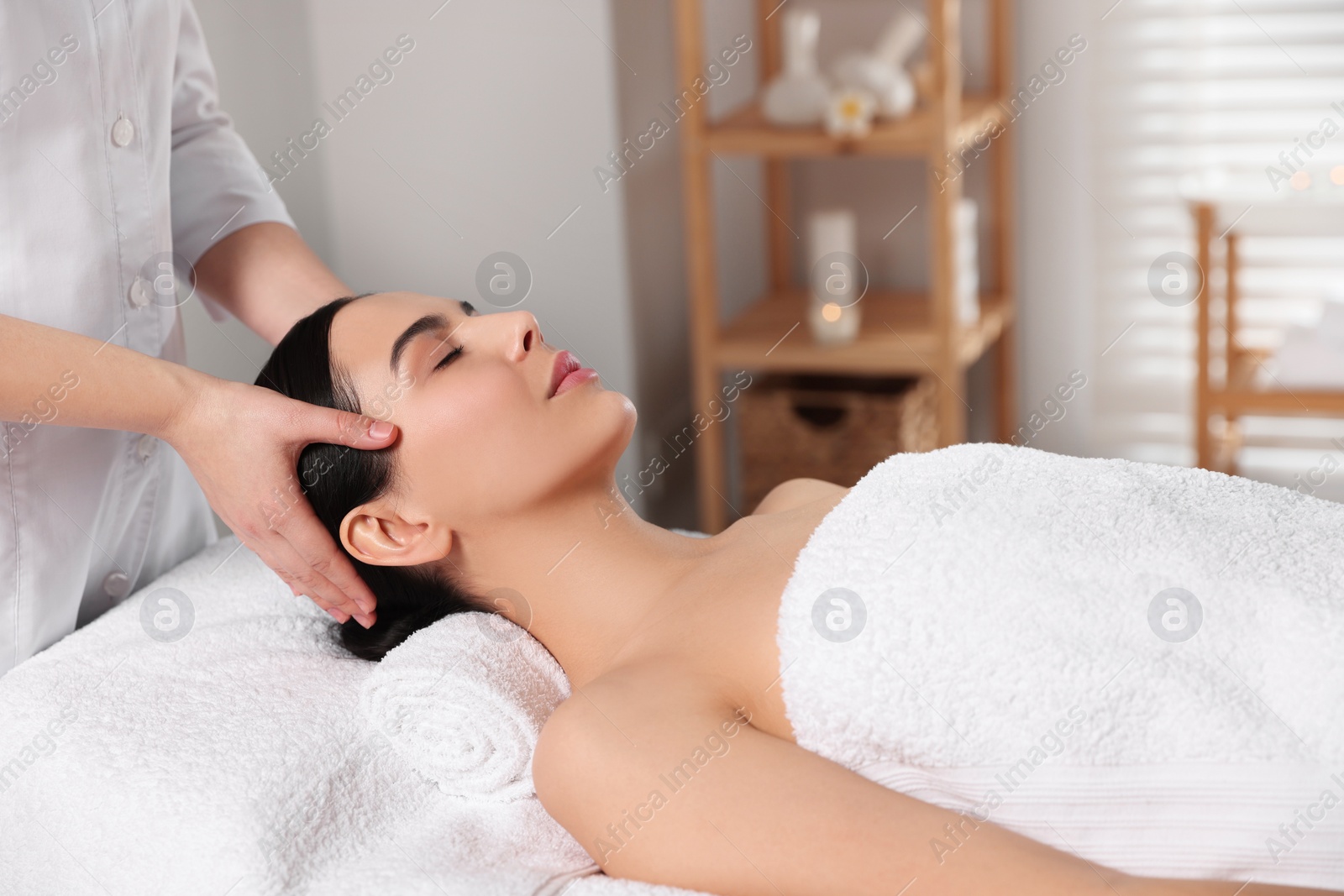 Photo of Beautiful woman receiving massage in beauty salon, closeup