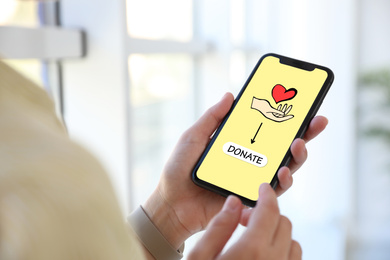 Image of Donations concept. Woman with smartphone indoors, closeup