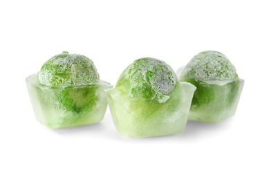 Photo of Brussels sprouts in ice cubes on white background. Frozen vegetables