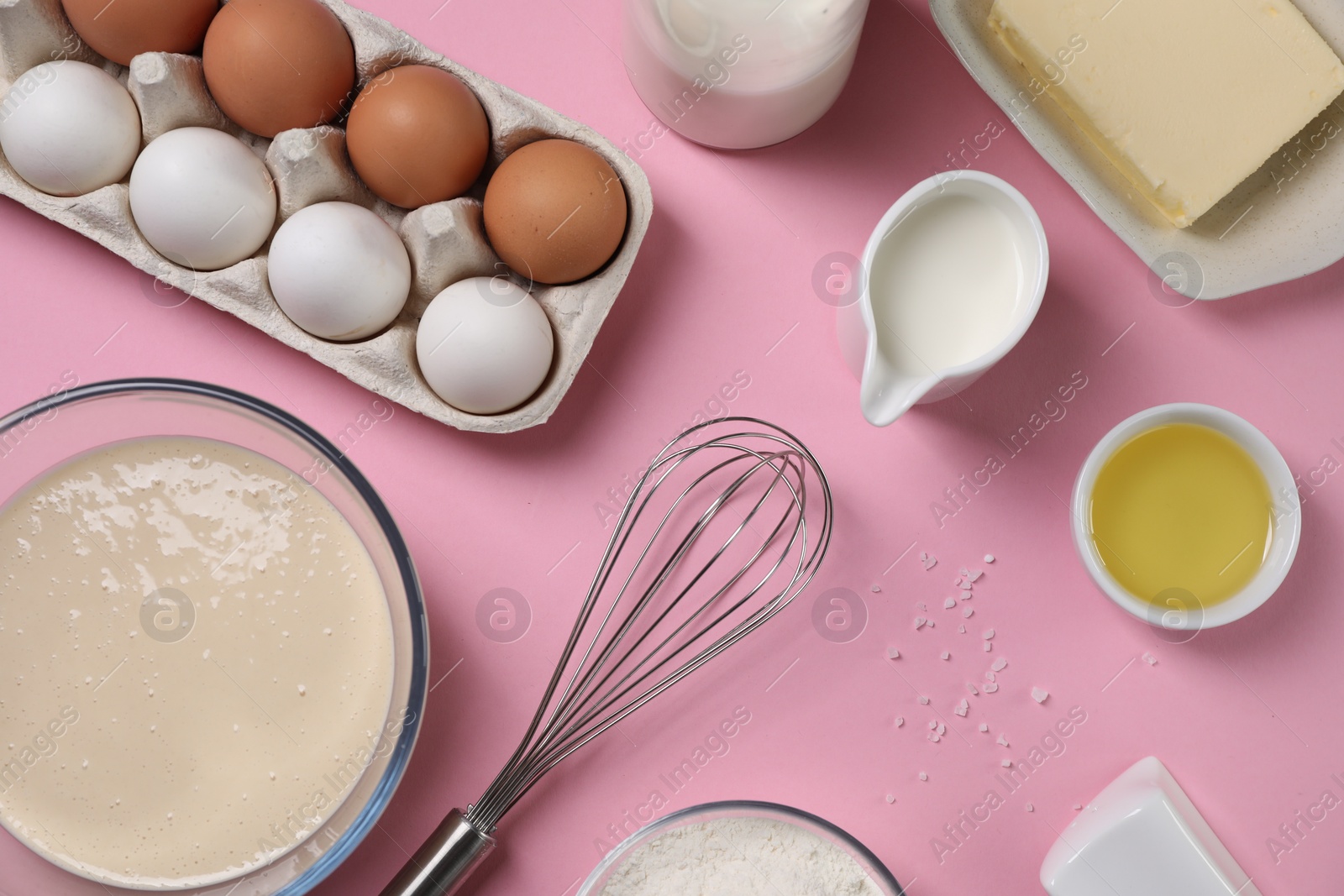 Photo of Flat lay composition with whisk and dough in bowl on pink background