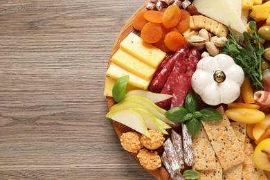 Different tasty appetizers on wooden table, top view. Space for text