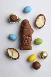 Photo of Flat lay composition with chocolate Santa Claus and sweets on white background