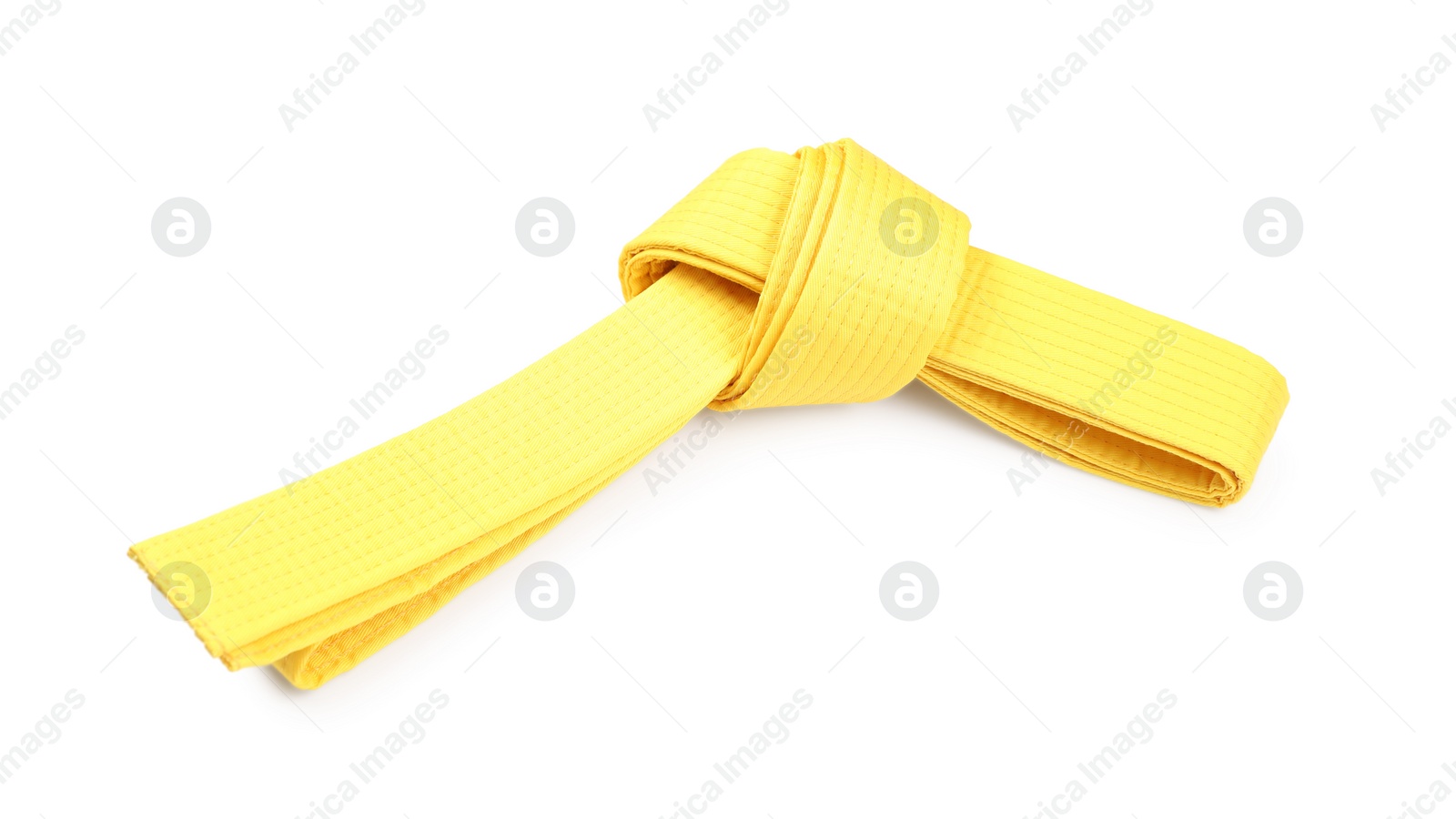 Photo of Yellow karate belt isolated on white. Martial arts uniform