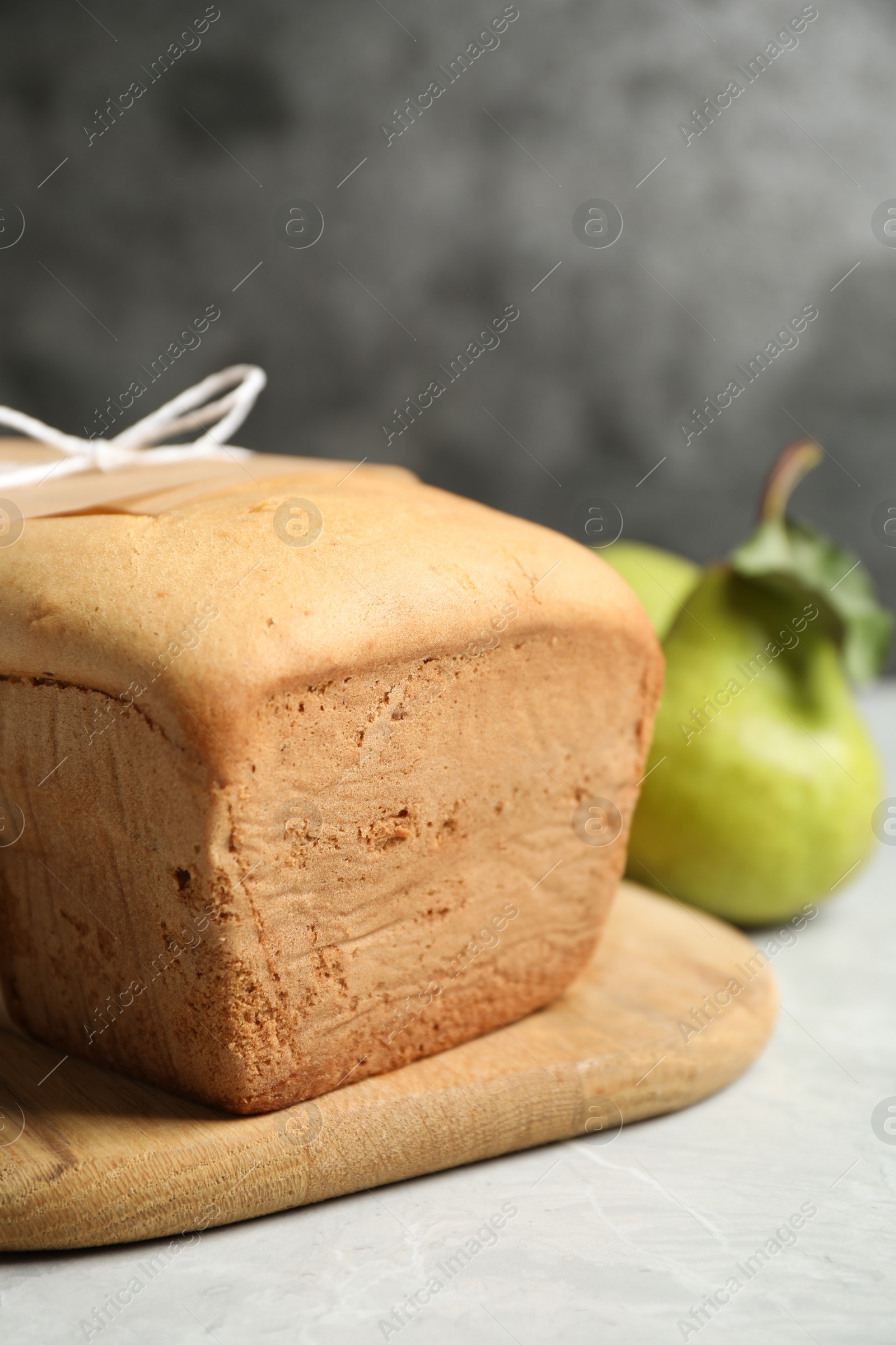 Photo of Tasty pear bread on light grey table. Homemade cake