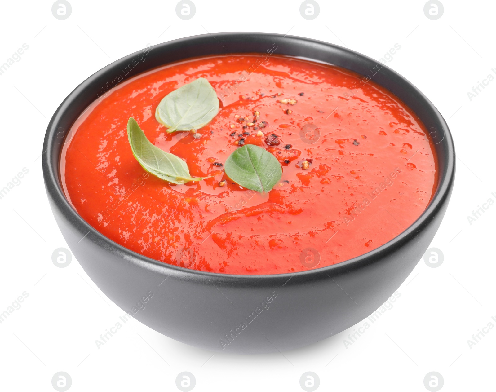 Photo of Bowl of delicious tomato cream soup isolated on white