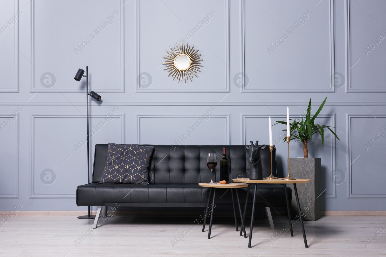 Photo of Stylish room interior with comfortable leather sofa and coffee table