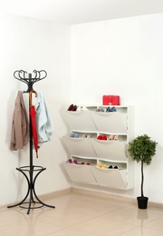 Shoe cabinet with footwear in room. Storage ideas