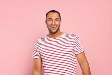 Photo of Portrait of happy African American man on pink background