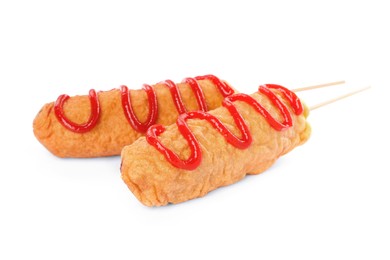 Delicious deep fried corn dogs with ketchup on white background