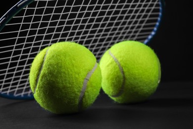 Photo of Tennis racket and balls on black background, closeup. Space for text
