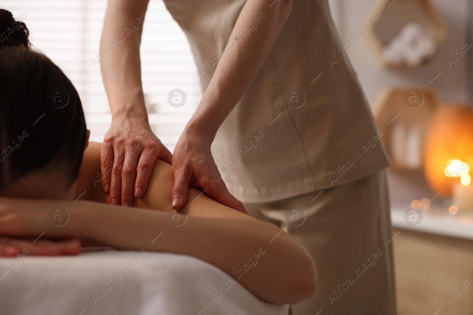 Photo of Woman receiving massage on couch in spa salon, closeup