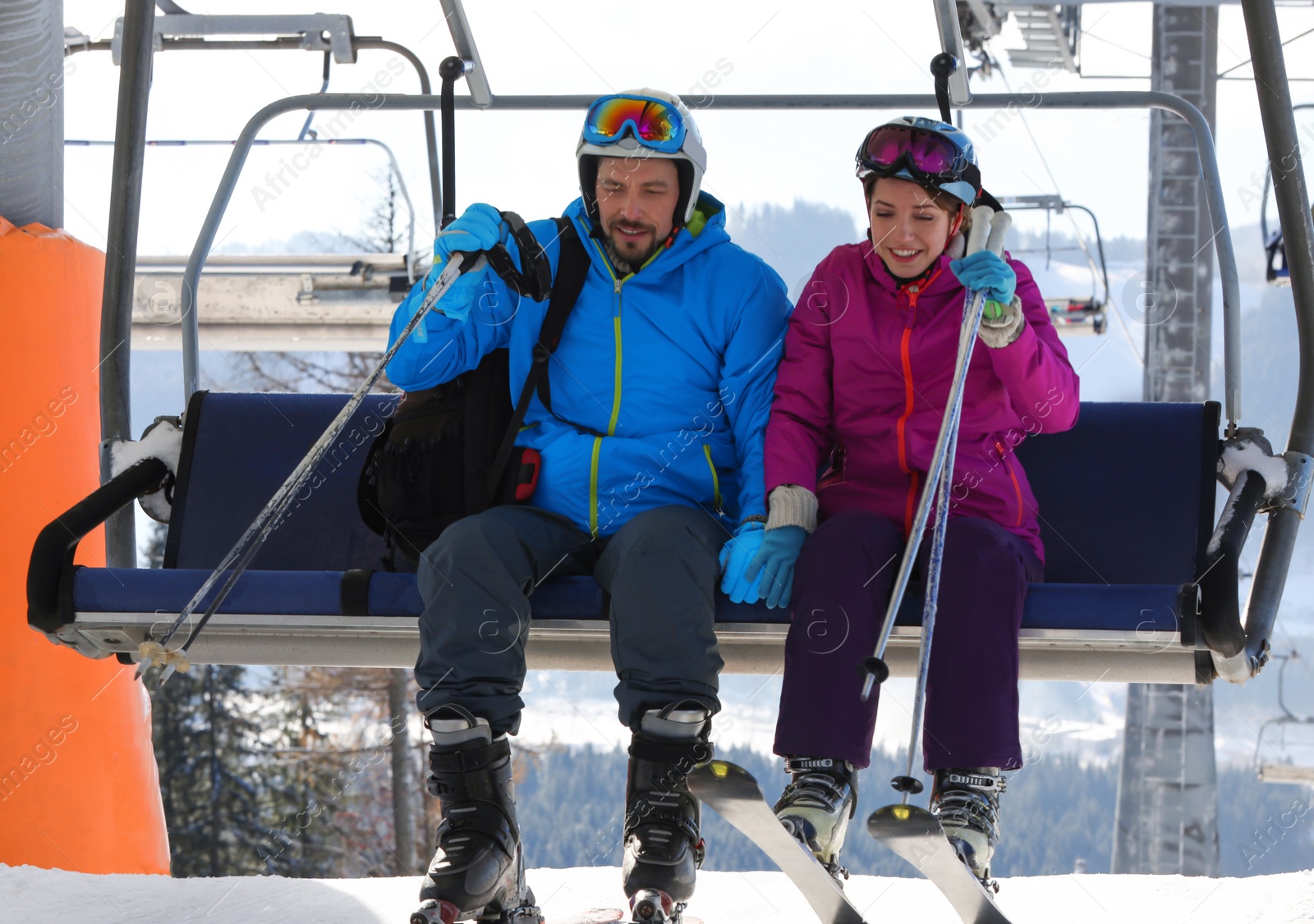 Photo of People using chairlift at mountain ski resort. Winter vacation