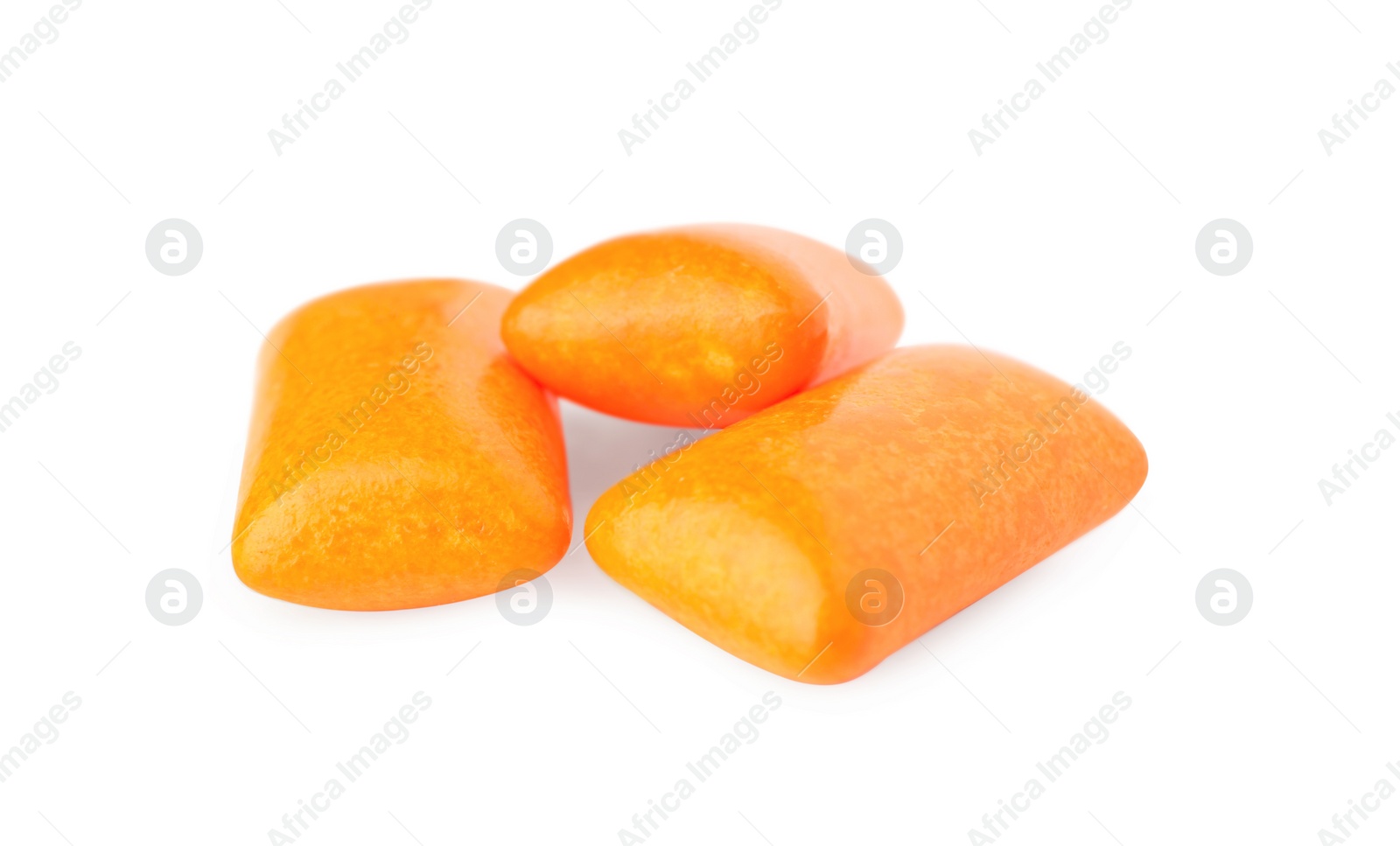 Photo of Tasty orange chewing gums isolated on white