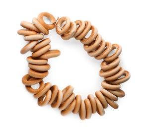 Photo of Bunch of delicious ring shaped Sushki (dry bagels) on white background, top view