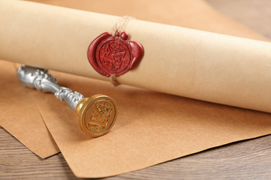 Notary's public pen and document with wax stamp on wooden table, closeup