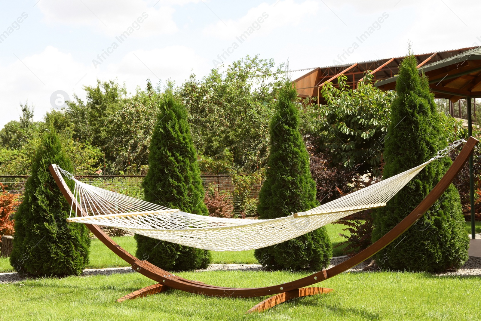 Photo of Empty comfortable hammock outdoors on sunny day