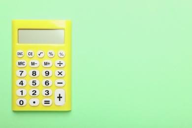 Calculator on green background, top view with space for text. Tax accounting concept