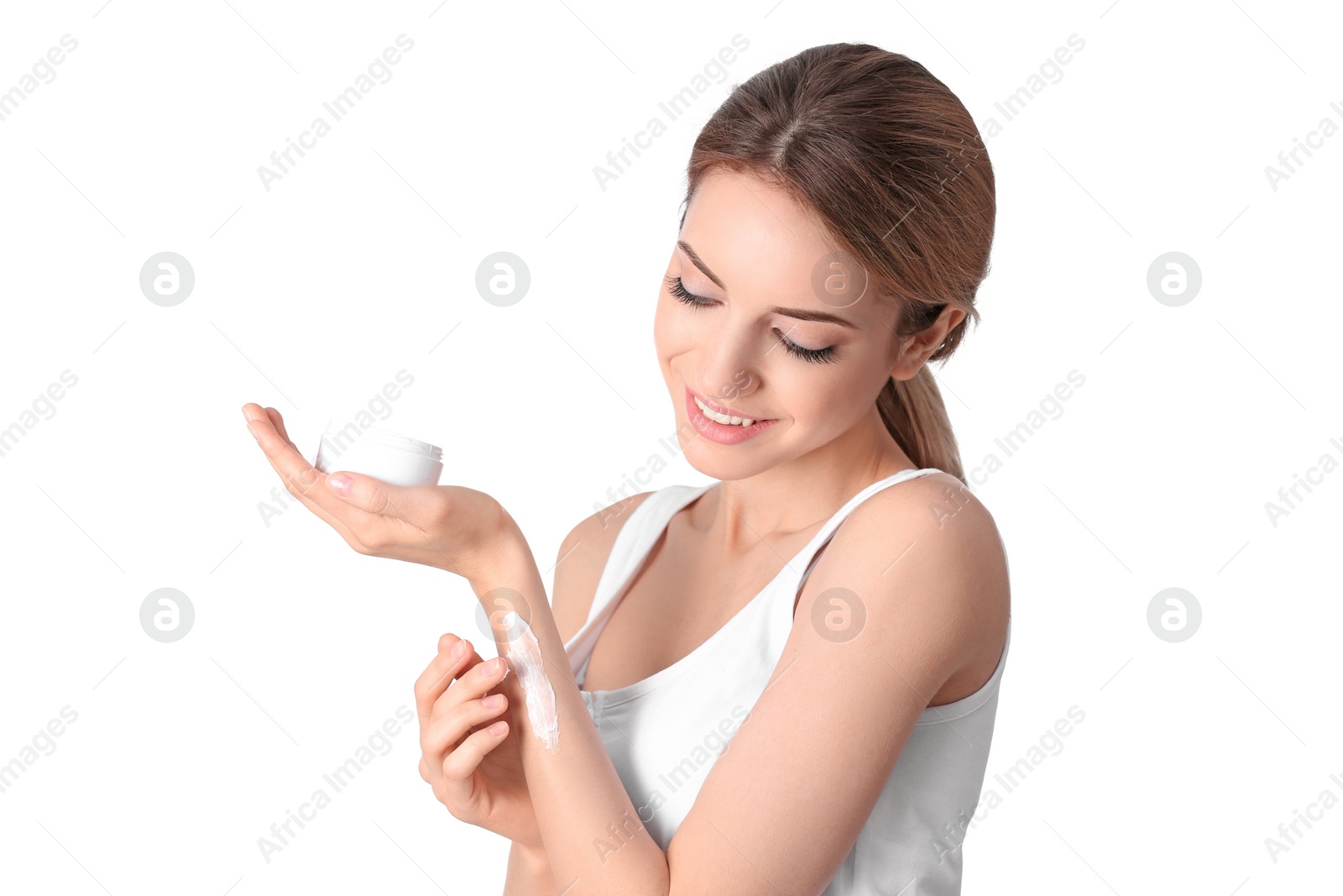 Photo of Young woman applying hand cream on white background