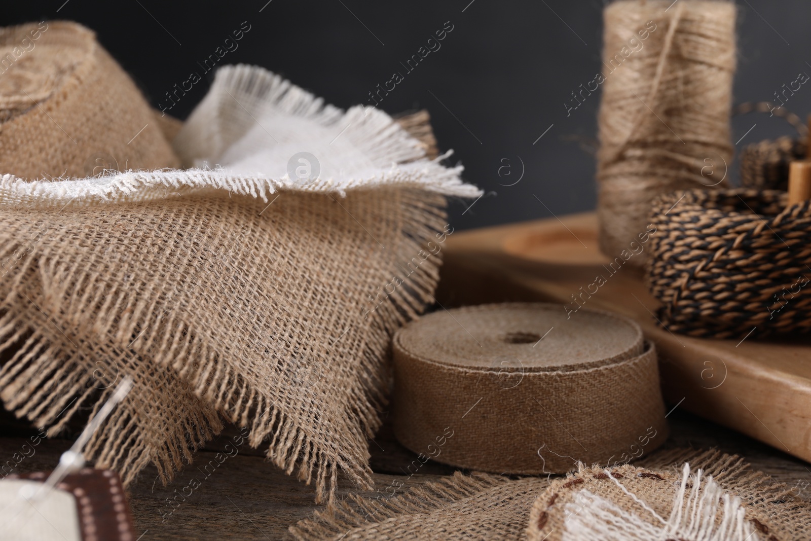 Photo of Pieces of burlap fabric on wooden table