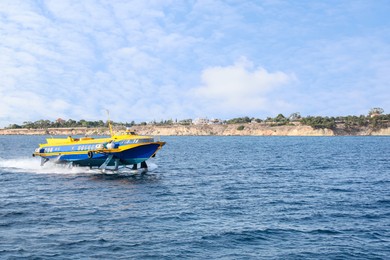 Modern passenger hydrofoil boat in sea on sunny day