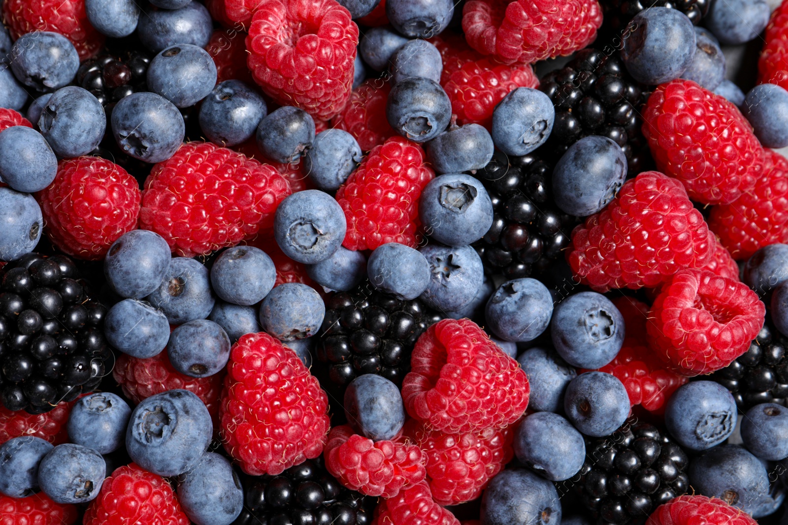 Photo of Assortment of fresh ripe berries as background, top view