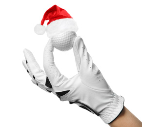 Image of Player holding golf ball with small Santa hat on white background, closeup